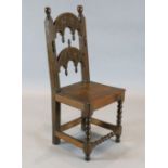 A 17th century Derbyshire oak side chair, with carved and turned arched back and solid seat on
