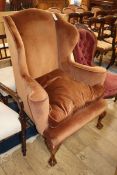 A 1920's upholstered wing armchair