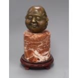 An Eastern bronze four mask Buddhistic head, on marble socle height 28cm. incl. wood stand