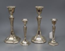 A pair of George V silver pillar waisted candlesticks (Chester 1911) and a smaller pair of