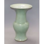 A Chinese Gu-shaped celadon vase, with floral decoration in relief and unglazed base, H 35.5cm