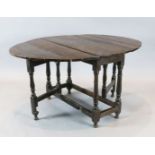 An early 18th century oak oval topped gateleg dining table, with turned and squared underframe,