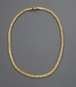 A 750 yellow metal fancy bead and brick-link necklet, 39cm, approx. 30 grams.