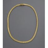 A 750 yellow metal fancy bead and brick-link necklet, 39cm, approx. 30 grams.