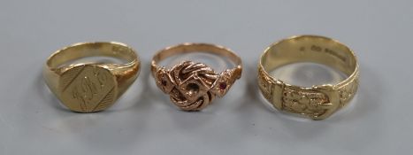 A 9ct gold 'belt' ring, a 9ct gold signet ring and a 9ct gold and ruby knot ring (central stone