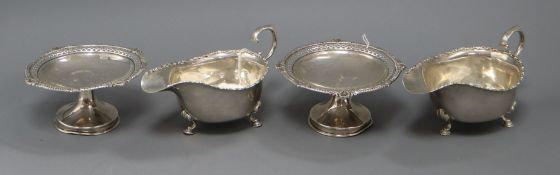 A pair of George V silver tazze with pierced gadroon and shell rims and a pair of silver sauceboats,
