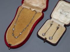 A diamond and white metal (tests as platinum) necklace set 14 old cut diamonds and a pair of diamond
