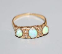 An early 20th century, 18ct gold, three stone white opal and diamond chip set ring, chip to