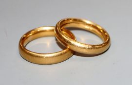 A 22ct gold wedding band and one other yellow metal wedding band.