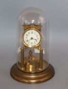 A brass torsion clock under glass dome