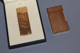 A cased Dunhill textured gold plated lighter and a Dupont lighter.
