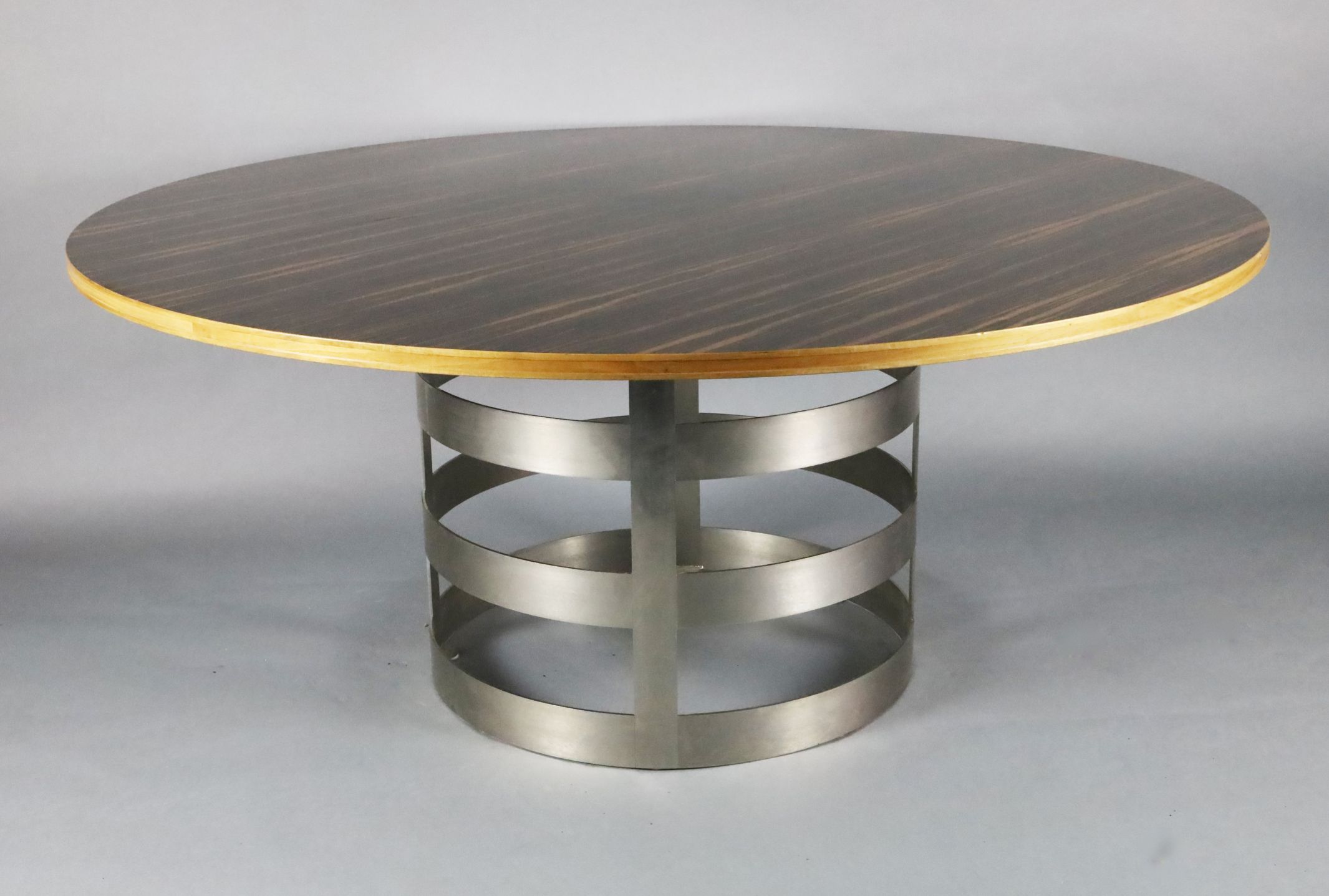 A contemporary macassar ebony veneered circular dining table, with brushed steel strapwork drum - Image 2 of 2