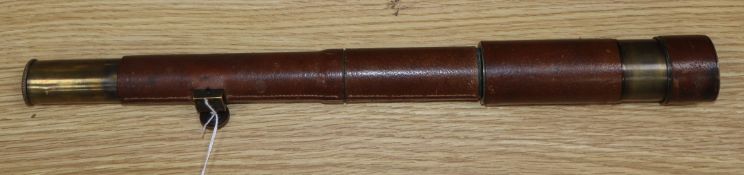 A leather cased three draw military telescope