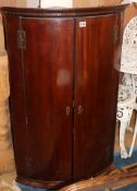 A George III mahogany bow-fronted corner cupboard W.69cm