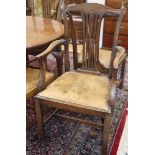 A set of seven Chippendale style mahogany dining chairs, one with arms