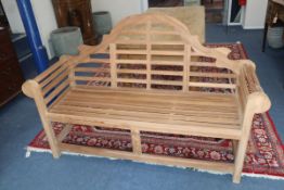 A Lutyens style teak garden bench