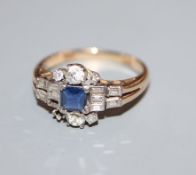 An Art Deco style 14k yellow metal, sapphire and diamond cluster ring (two stones missing), size O.