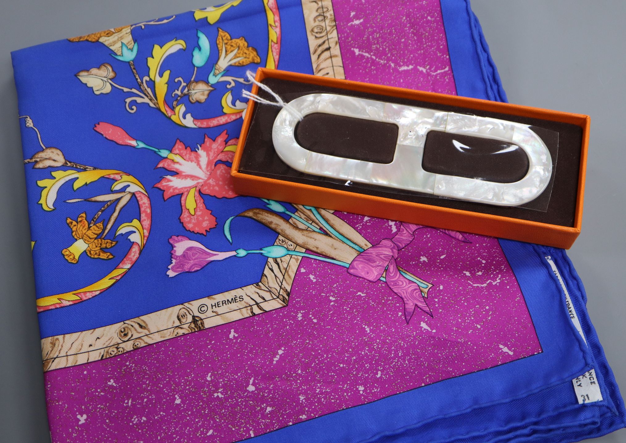 Two Hermes silk scarves, 'Neige d'Antan' and 'Pierres d'Orient et d'Occident' and a 'Chaine d'Ancre'
