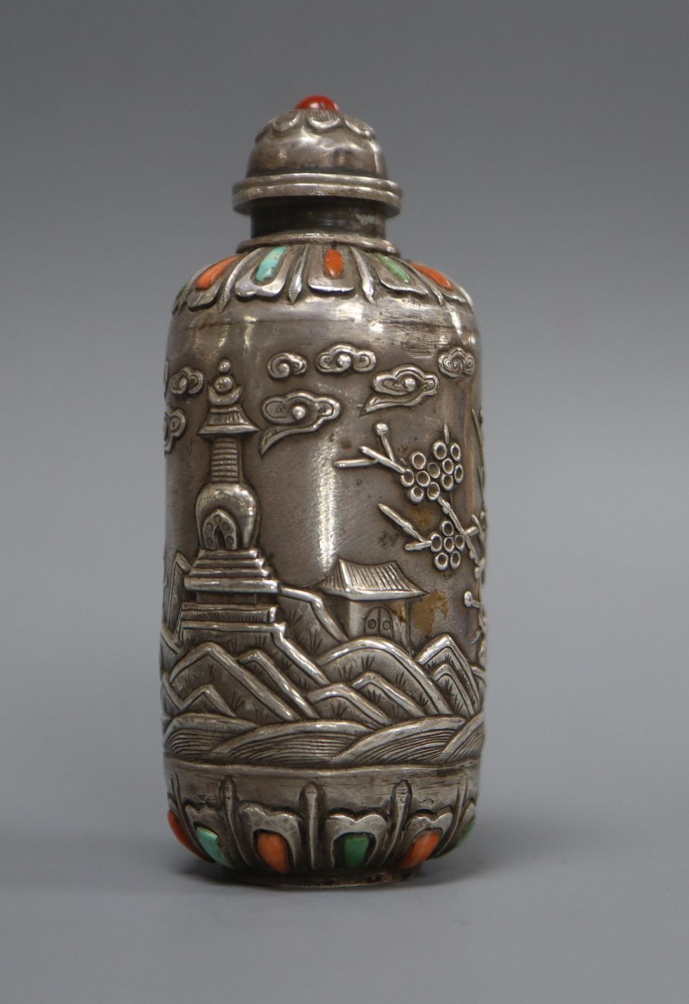 A Mongolian-style mounted white metal snuff bottle