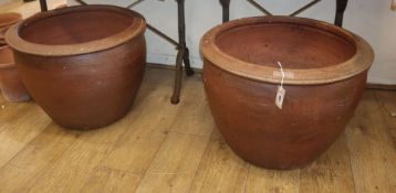 A pair of large earthenware garden planters 64cm diameter