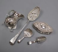 A George III embossed silver cream jug, London 1770, a George III shell-bowl caddy spoon and three