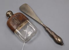 A silver mounted leather covered glass spirit flask and a silver handled shoe horn.