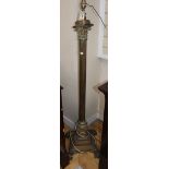 A brass paw footed Corinthian column adjustable standard lamp