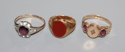 A 9ct gold signet ring with carnelian matrix, a 9ct diamond and amethyst gypsy-set ring and a 9ct