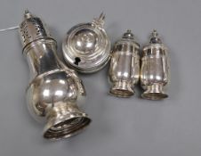 A George V silver sugar caster and a 1930's silver three piece condiment set.