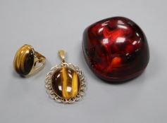 A yellow metal mounted tiger's eye quartz oval pendant and a similar dress ring.