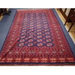 A red and blue ground Bokhara carpet 305 x 210cm