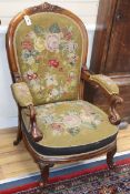 A large Victorian library armchair, upholstered in original needlework