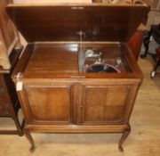 A 1920's oak cabinet gramophone, with records W.87cm