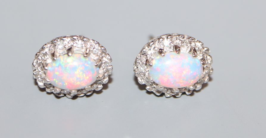 A pair of 18k white metal, white opal and diamond oval cluster ear studs, 11mm.