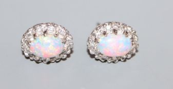 A pair of 18k white metal, white opal and diamond oval cluster ear studs, 11mm.