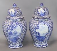 A pair of large 19th century Delft blue and white vases and covers height 40cm