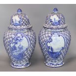 A pair of large 19th century Delft blue and white vases and covers height 40cm