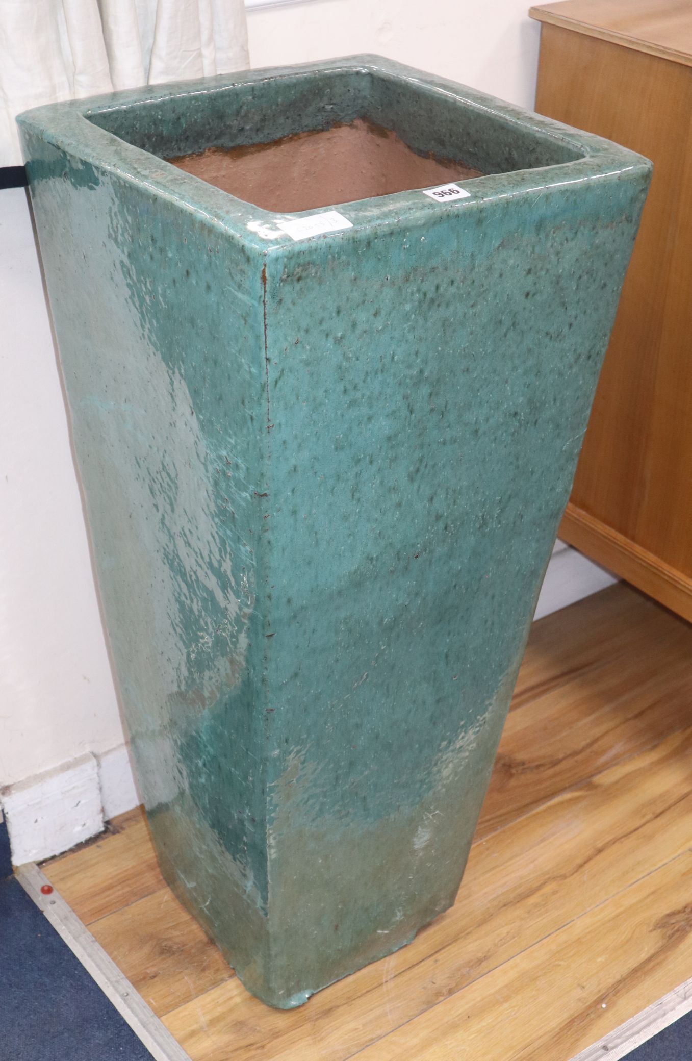 A tall green garden planter H.90cm