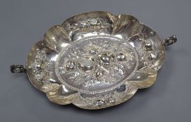 A German 800 white metal two handled oval dish, embossed with fruit, 29cm over handles.