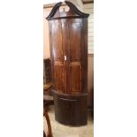 A George III mahogany bow-fronted standing corner cupboard H.230cm