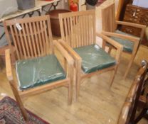 A set of six teak garden elbow chairs