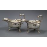 A pair of early George III silver sauceboats with flying scroll handles, maker, F.M, (unidentified