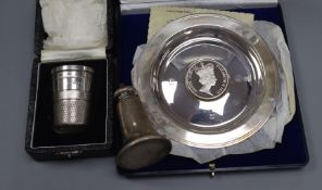 A Queen Elizabeth II silver medallion dish, a silver pepper and silver 'just a thimbleful' cup.