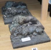 A set of four bronze recumbent lions