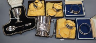 A silver Christening egg cup and spoon set, cased, a half-wrythen silver Christening mug and four