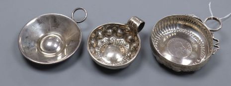 Three assorted 19th century and later French white metal taste vin, including one with inset coin