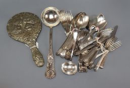 A plated hand mirror and assorted cutlery