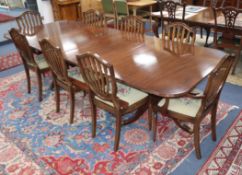 A set of 8 Hepplewhite style mahogany dining chairs and a Regency mahogany two pillar dining table