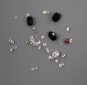 A small quantity of assorted small loose cut gemstones including diamonds.