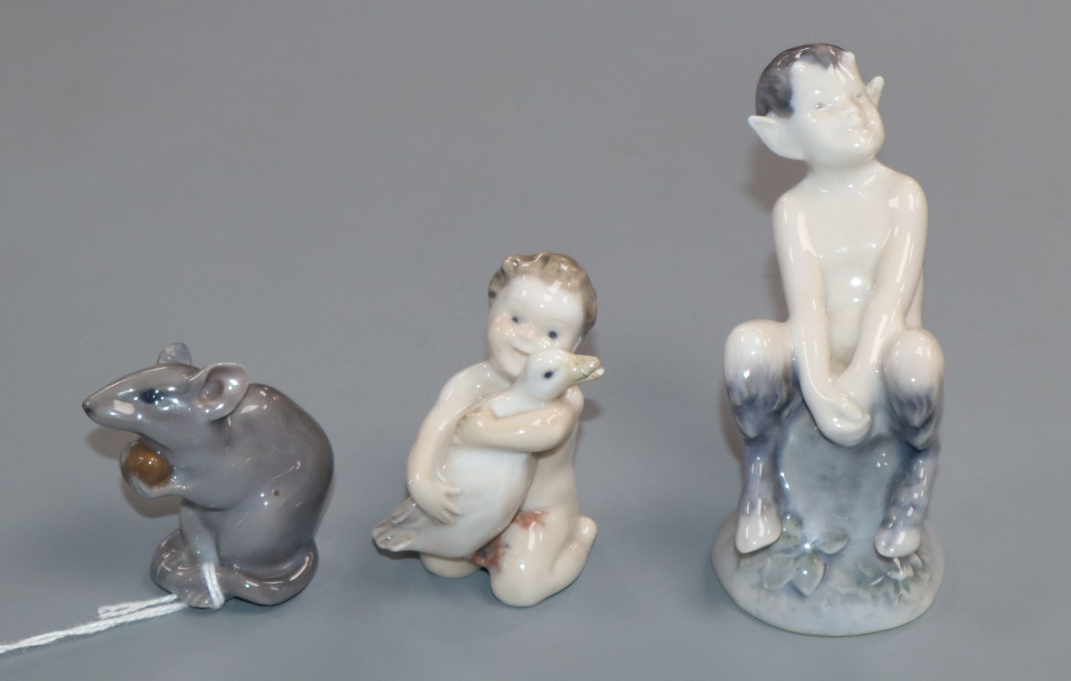 Three Royal Copenhagen figures, Mouse with nut, No. 344, Boy with duck, No. 2332 and Faun on a
